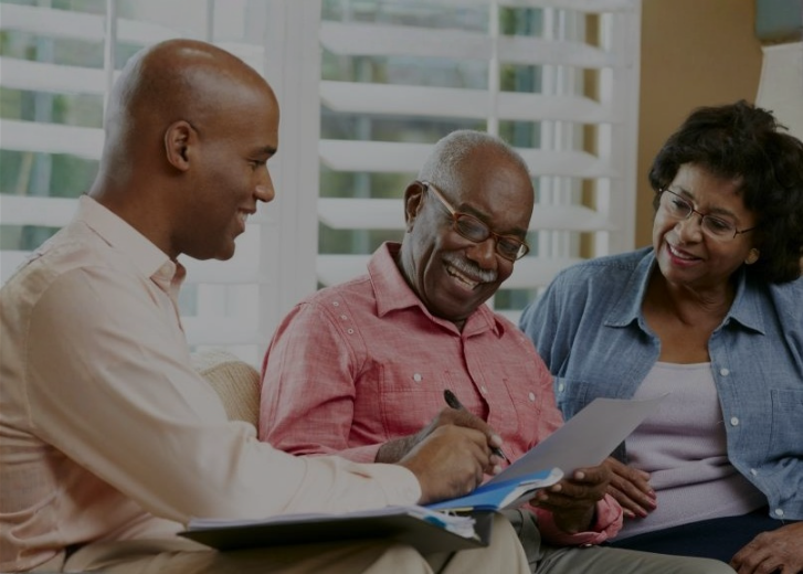 Man showing older couple paperwork